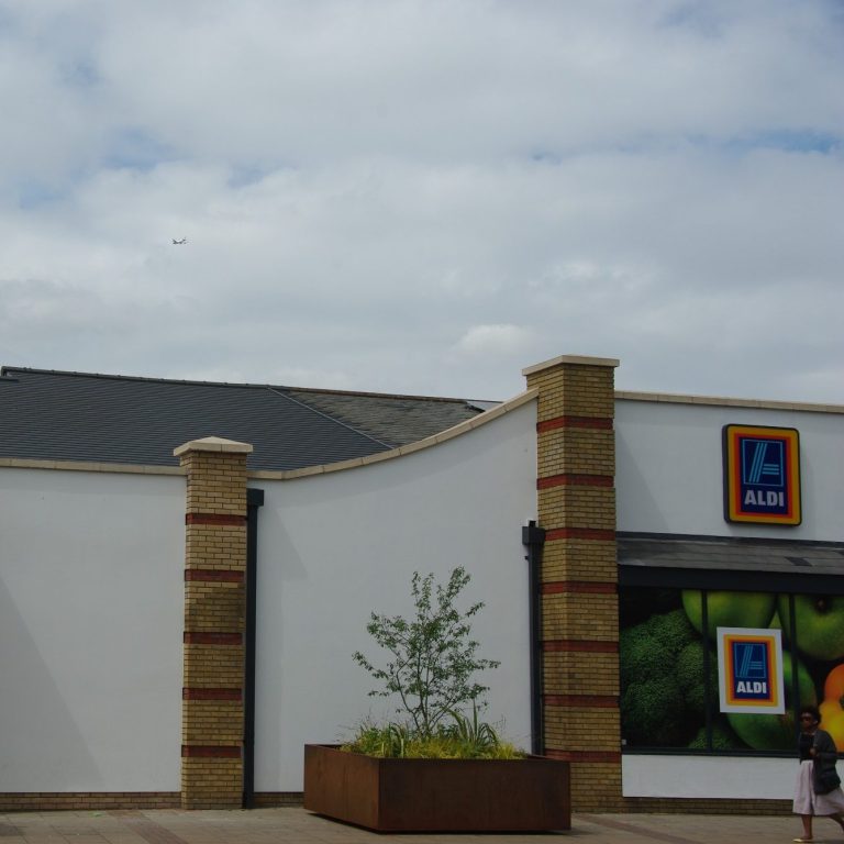 Newly constructed Aldi supermarket with sleek, Envirotile roof tiles, highlighting the modern eco-friendly design of the commercial building