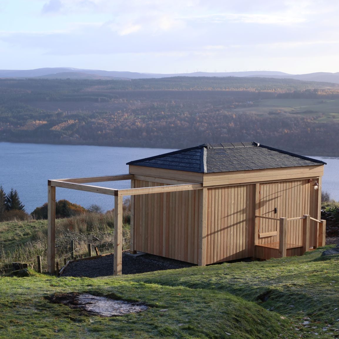 Roof fitted with Envirotile roof tiles overlooking a scenic sea background, showcasing the tile’s durability and aesthetic appeal